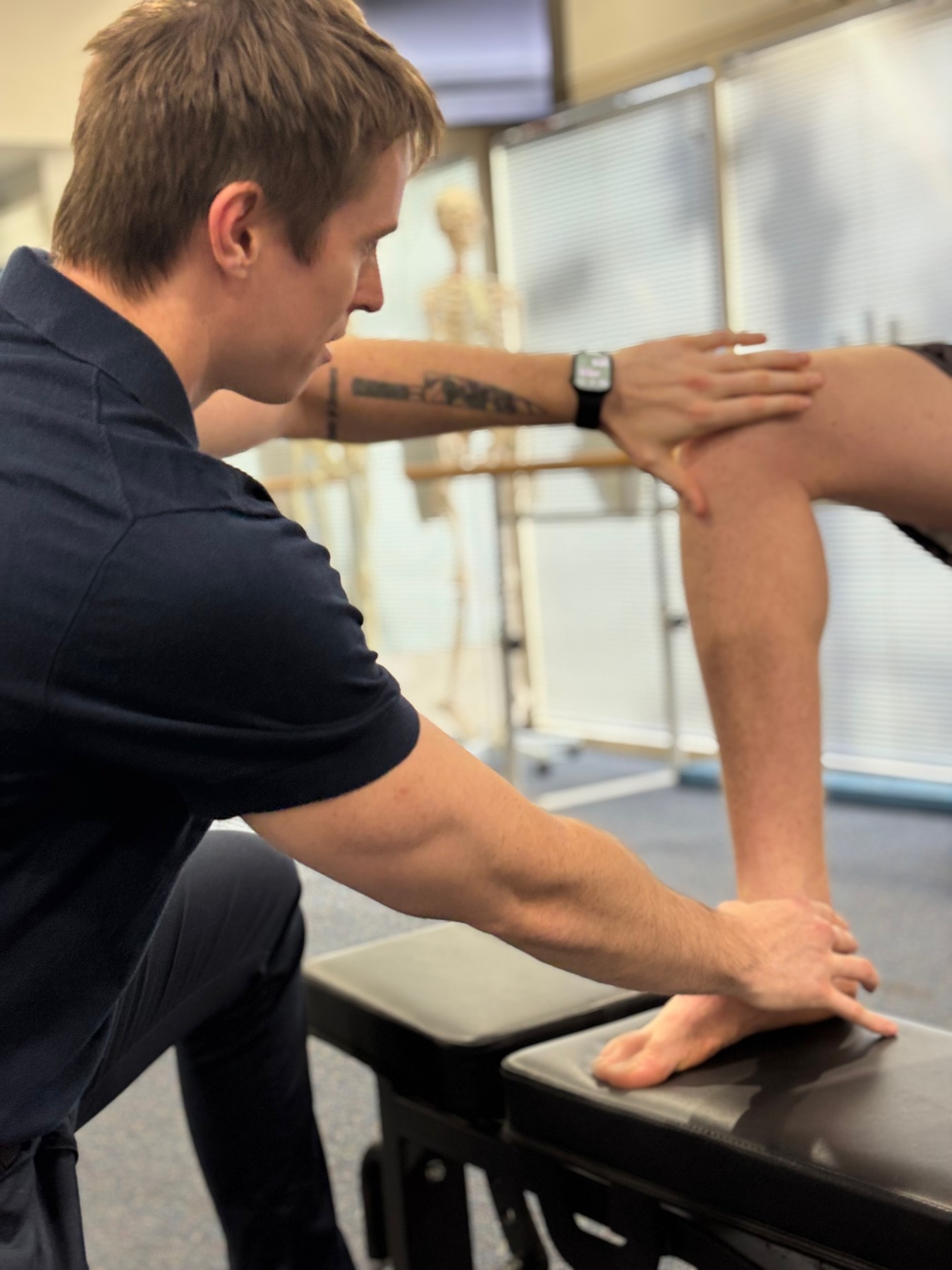 Physiotherapist assessing a patient's knee movement